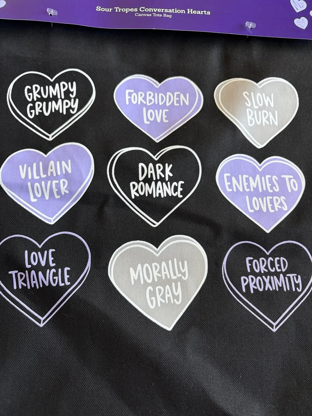 Out of Print Black Tote Bag with Purple and Gray Conversation Hearts